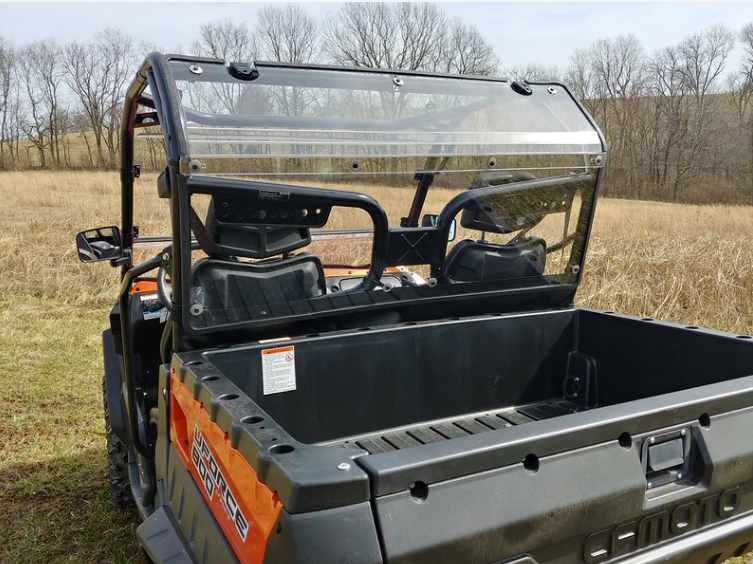 3 Star clear Lexan back panel installed behind the seats of an orange CF Moto UForce, viewed from the bed