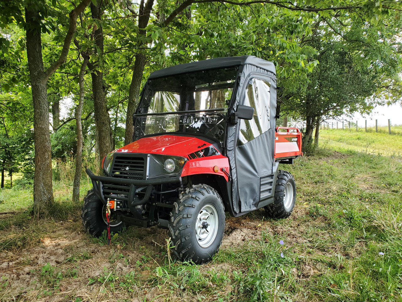 3 Star full cab enclosure installed on a red Coleman/Hisun 400 with hard windshield, front three-quarter view