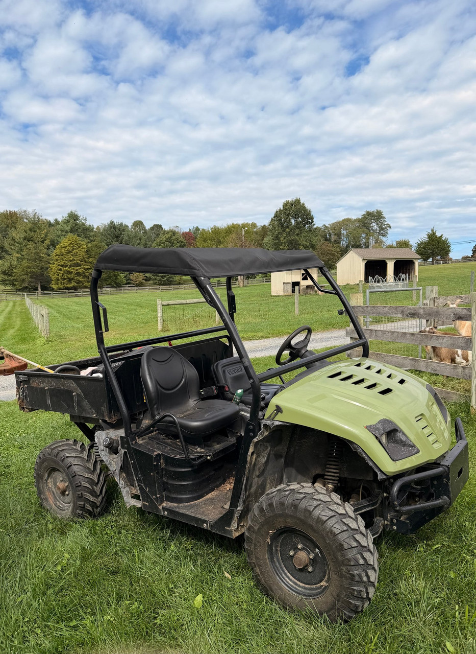 Black Greene Mountain soft top roof cover installed on a green Cub Cadet Volunteer UTV, side view