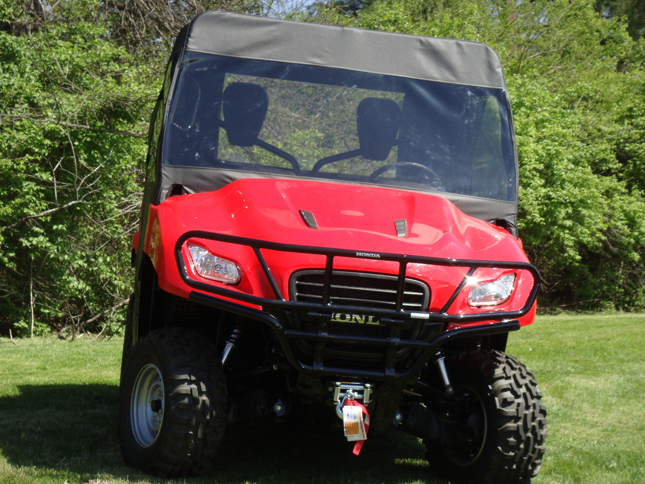 Front view of a red Honda Big Red with the 3 Star vinyl windshield and soft top combo installed