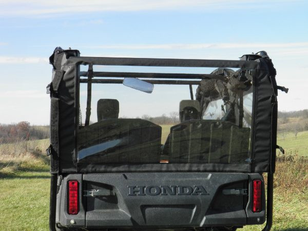 Close rear view of the 3 Star vinyl rear window on a Honda Pioneer 700, clear panel showing the seats and mirror