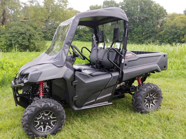 3 Star vinyl windshield and soft top combo on a gray Honda Pioneer 700, driver side front angle in a field