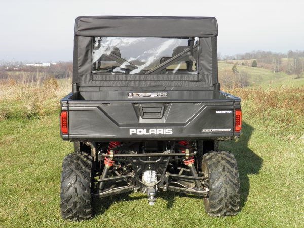 Rear view of a white Polaris Ranger with the 3 Star cab enclosure rear window panel installed