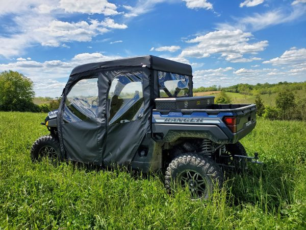 Rear three-quarter view of a blue Polaris Ranger 1000 Crew with the 3 Star soft doors and a soft top