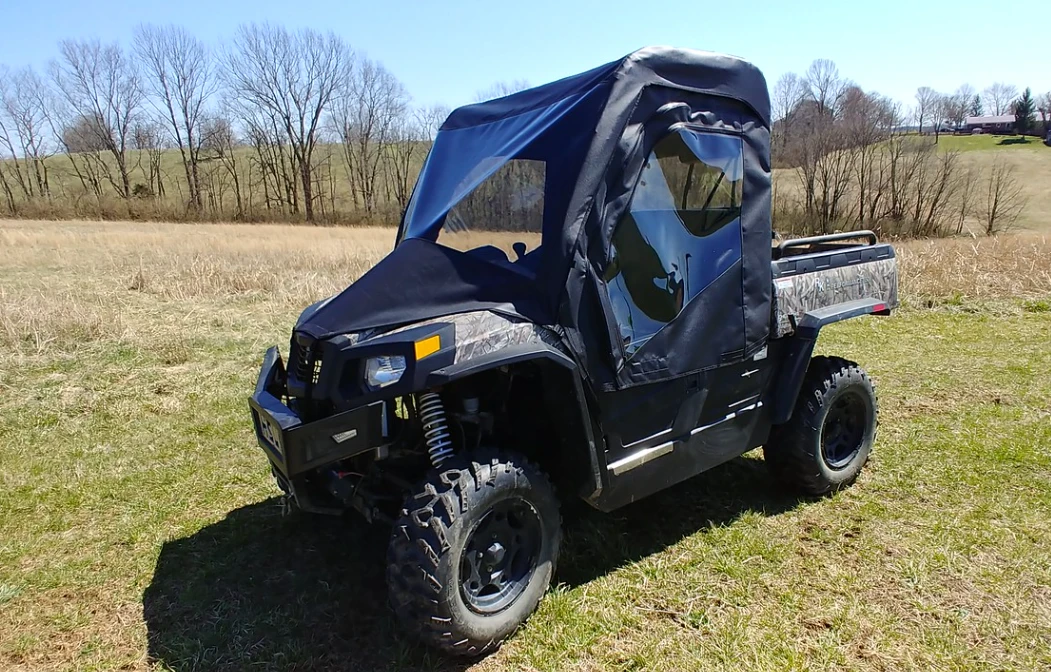 3 Star full cab enclosure with vinyl windshield on a camouflage Hisun 500, front three-quarter view in a field