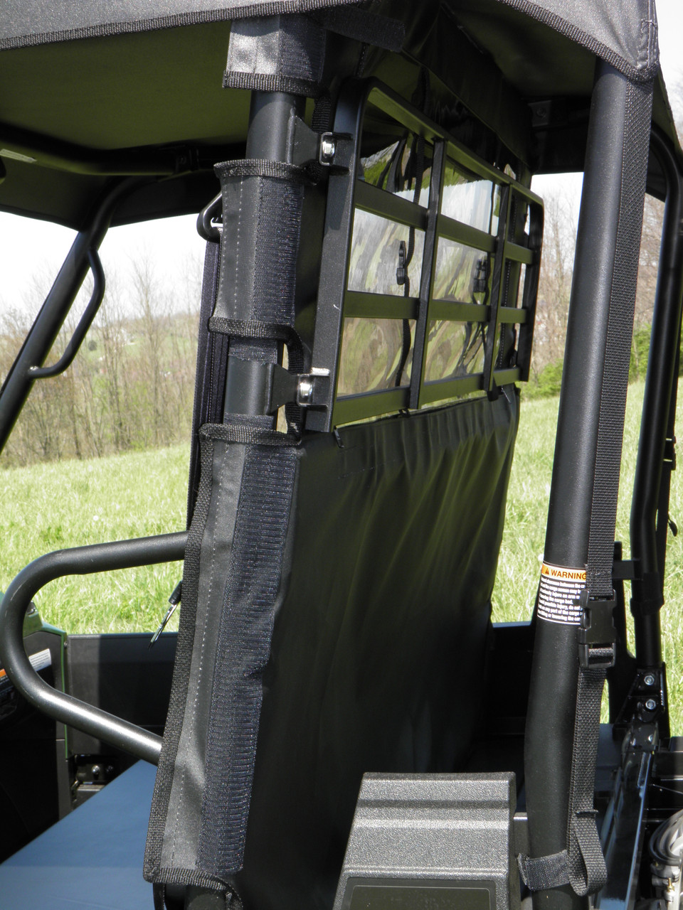 Side close-up of the 3 Star soft back panel edge strapped to the roll cage of a Kawasaki Mule ProMX
