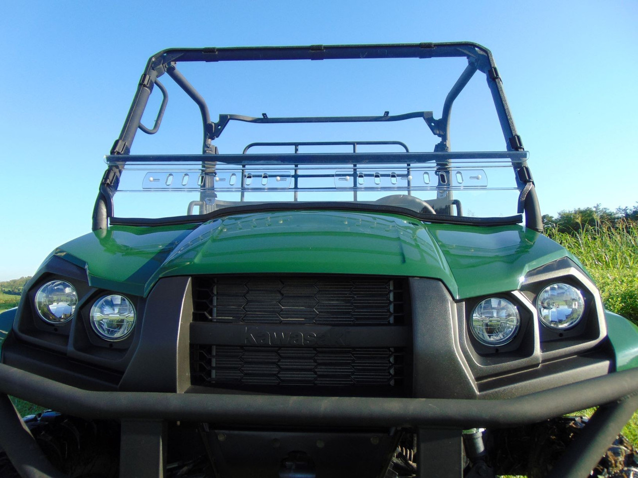 3 Star clear two-piece windshield on a green Kawasaki Mule Pro-MX, front close-up view outdoors