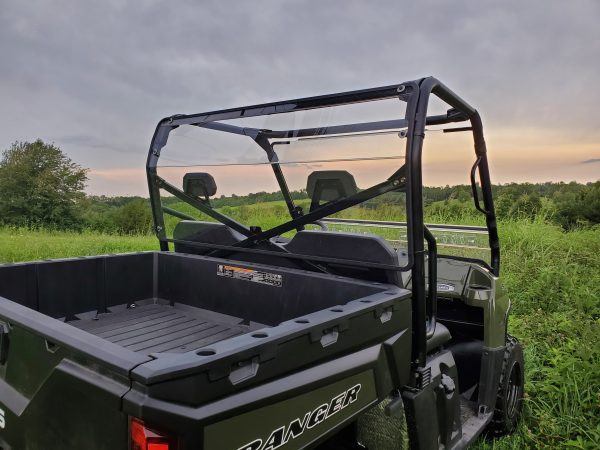 Driver side rear three-quarter view of a green Polaris Ranger 570 with the 3 Star Lexan back panel installed