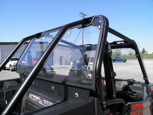 Rear view of a Polaris RZR with the 3 Star clear Lexan back panel installed, buildings in the background