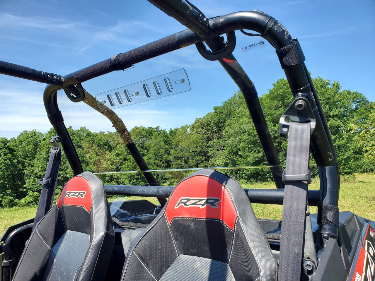 View from inside a Polaris RZR XP 4 showing the 3 Star clear Lexan back panel with vent behind the seats