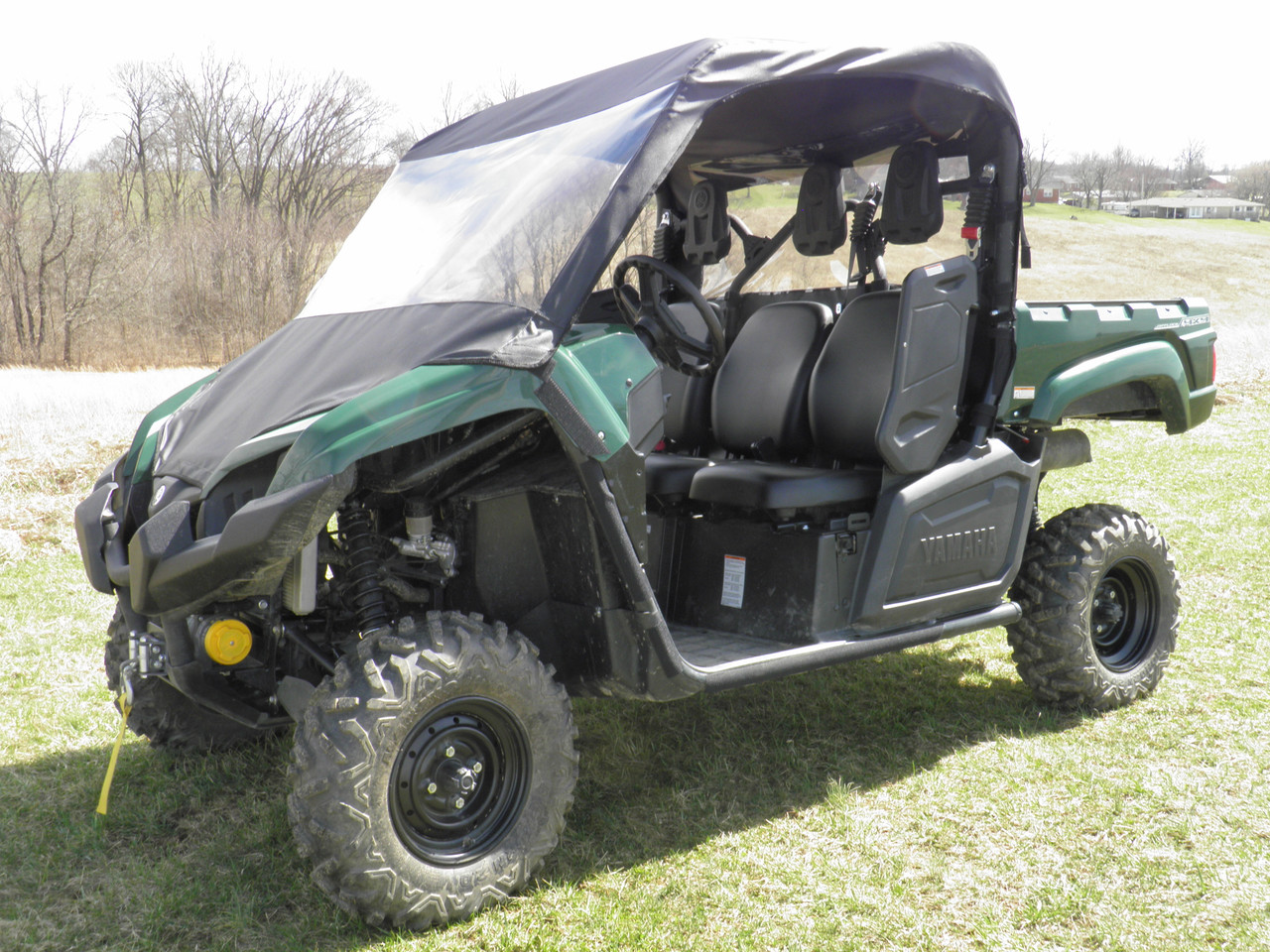 3 Star vinyl windshield and top on a green Yamaha Viking, driver side front three-quarter view in a field