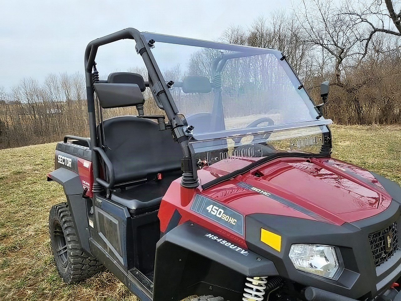 3 Star two-piece clear windshield installed on a red Hisun Sector 450, front three-quarter view showing the split