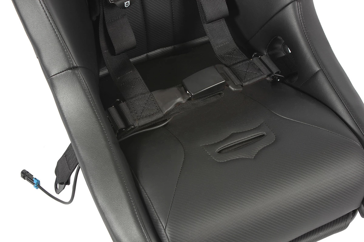 Close-up of the Pro Armor harness lap belt and auto-style buckle latched on a bucket seat with the sensor wire