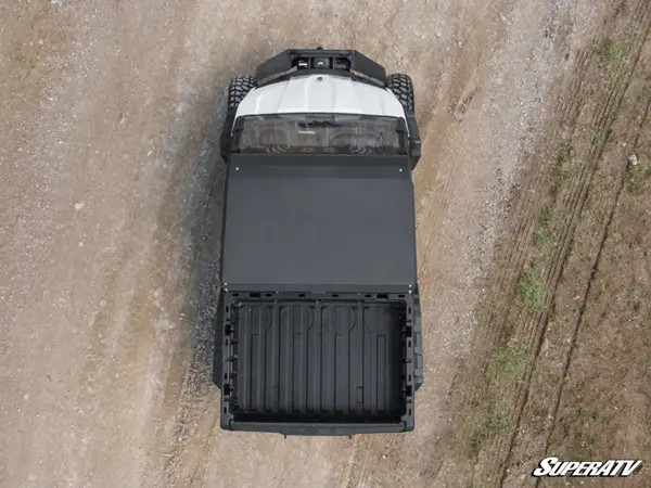 Top-down view of a Can-Am Defender HD10 showing the full SuperATV aluminum roof panel over the cab