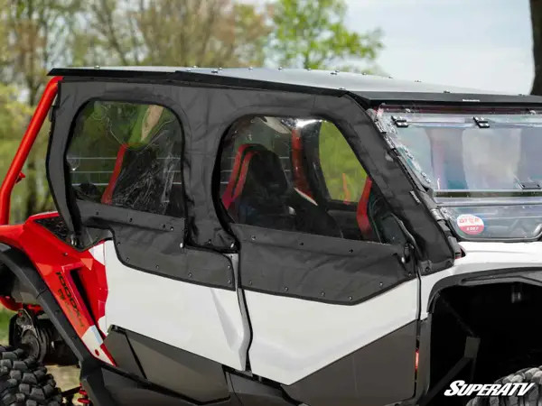 SuperATV soft upper doors with clear windows installed on a red and white Honda Talon 1000X-4, close side view