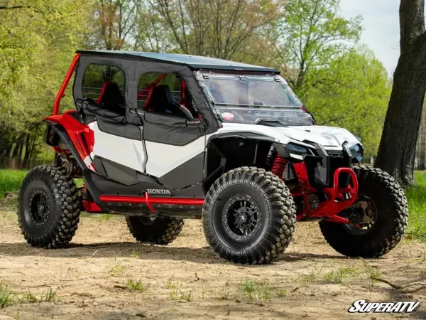 Front three-quarter view of the Honda Talon 1000X-4 in the woods with SuperATV soft upper doors on all four doors