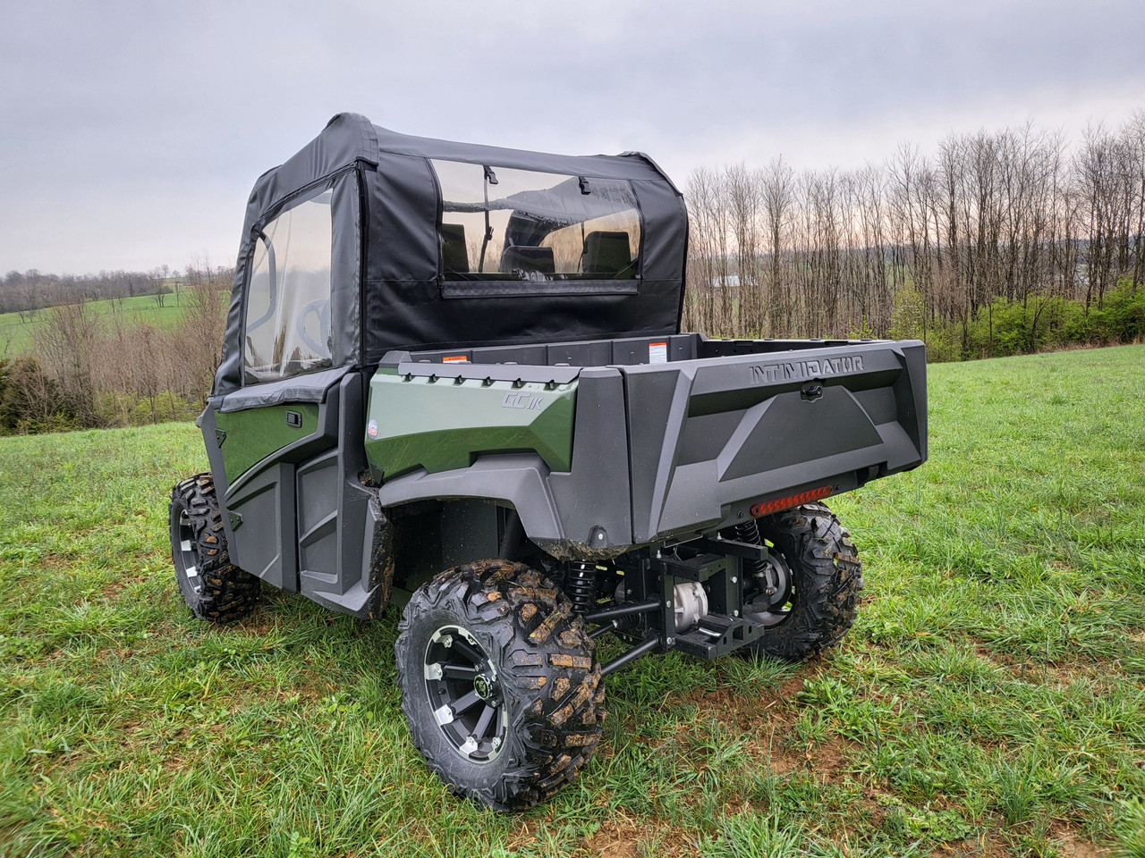 Rear three-quarter view of a green Intimidator GC1K with the 3 Star soft doors and clear rear window installed