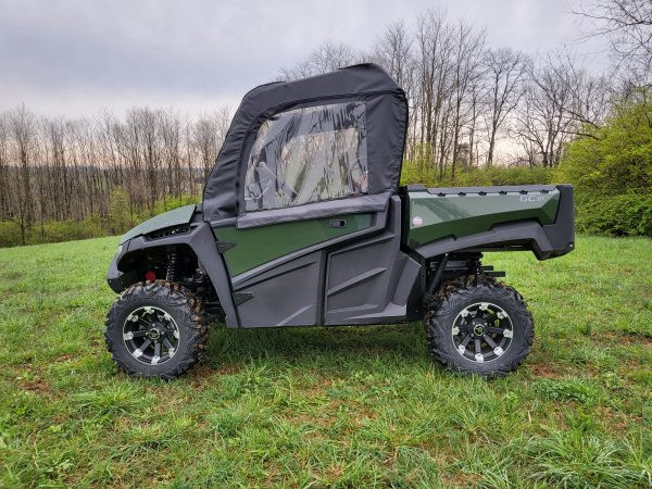 Side view of a green Intimidator GC1K with the 3 Star black soft doors with clear windows installed in a field