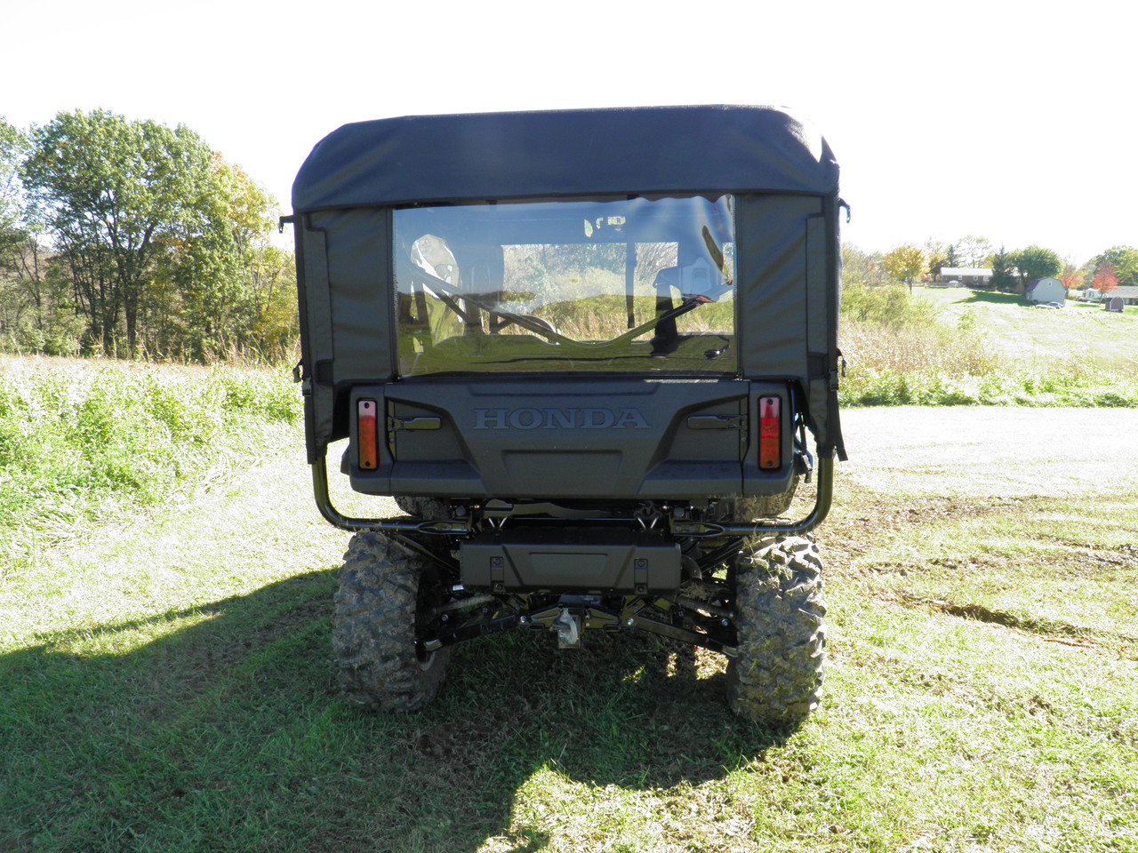Rear view of a blue Honda Pioneer 1000-5 with the 3 Star full cab enclosure rear panel and clear window