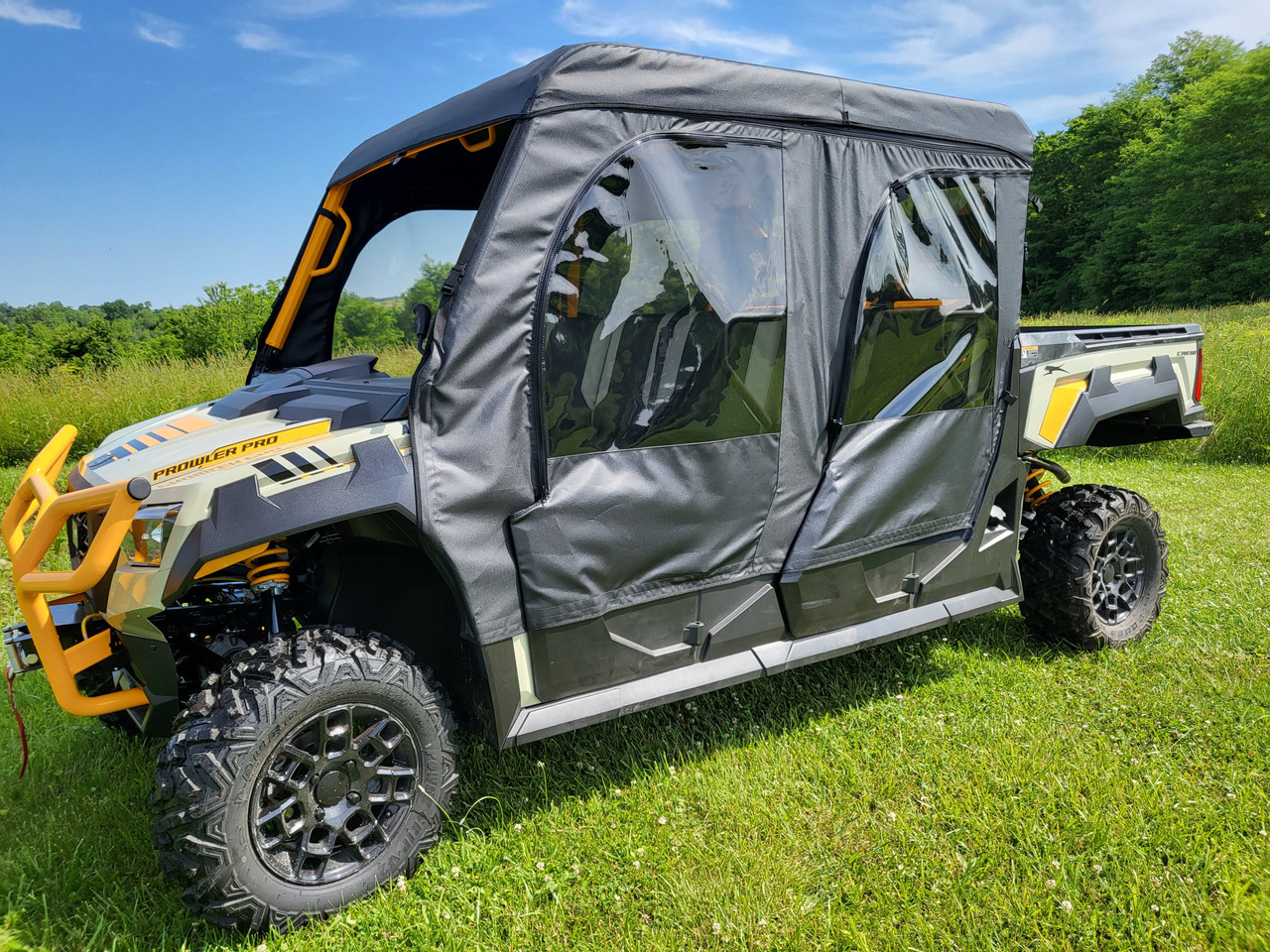 3 Star full cab enclosure with upper doors on a gray crew-cab side-by-side, driver side three-quarter view in a field