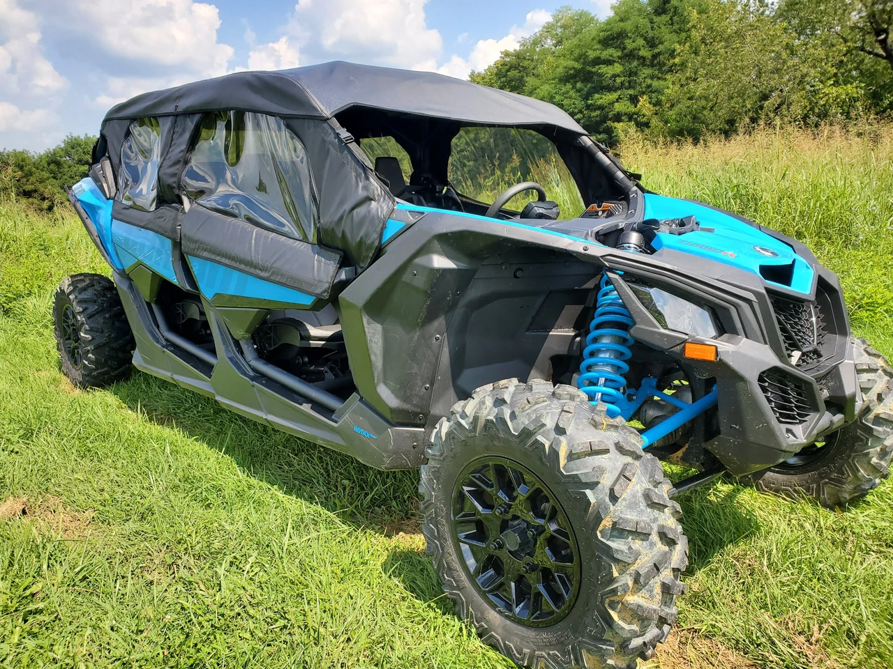 3 Star full cab enclosure on a blue Can-Am Maverick X3 Max with hard windshield, front three-quarter view