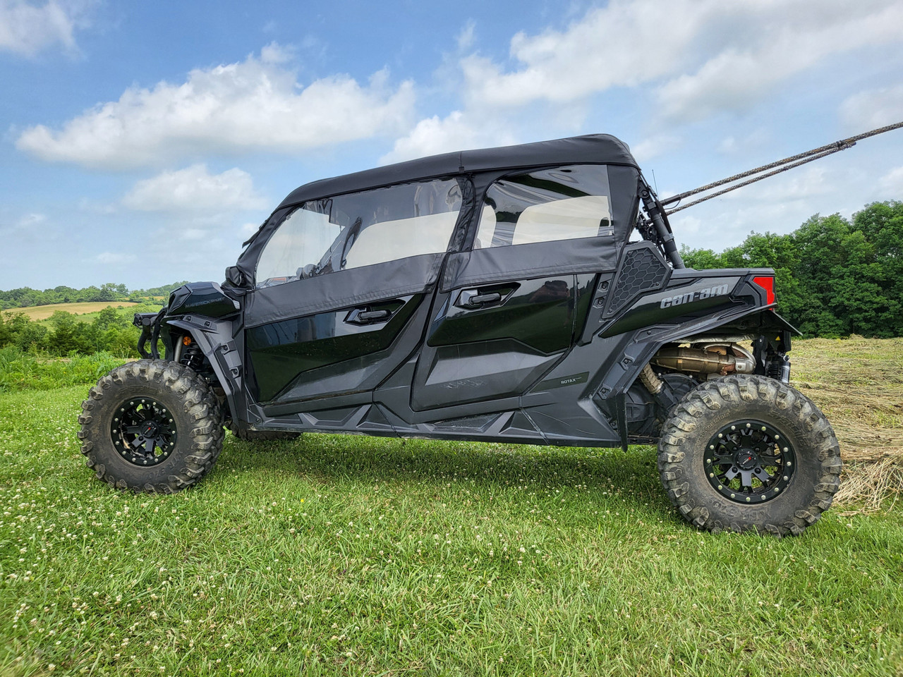 3 Star full cab enclosure for hard windshield on a black Can-Am Maverick Sport Max, driver side profile in a field
