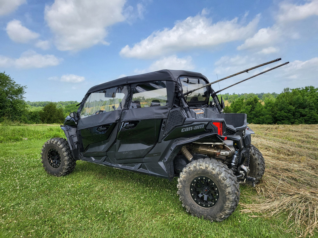 Rear three-quarter view of the 3 Star full cab enclosure on a Can-Am Maverick Sport Max with doors zipped shut