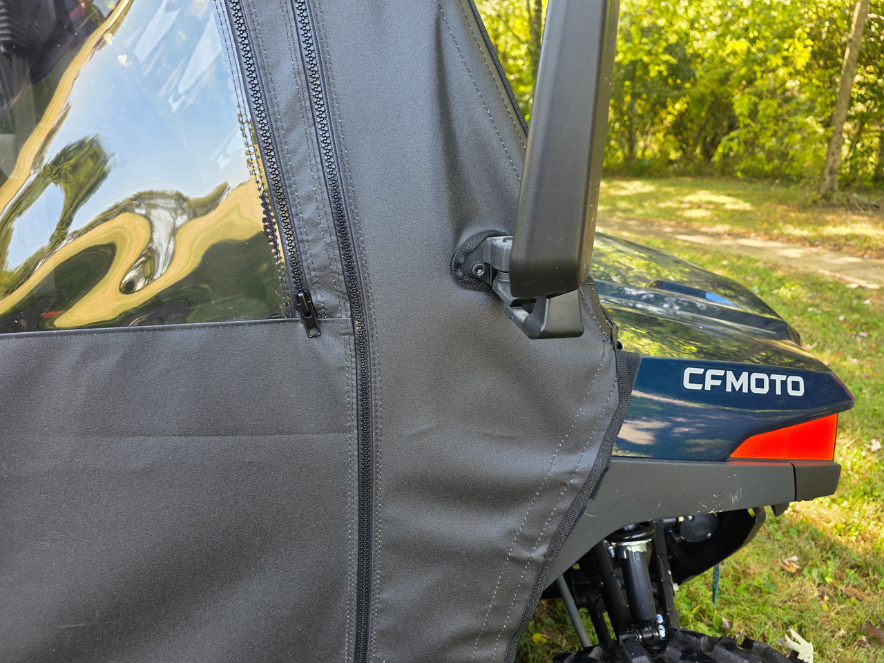 Close-up of the 3 Star full door zipper and mirror cutout on a blue CFMoto UForce 800XL