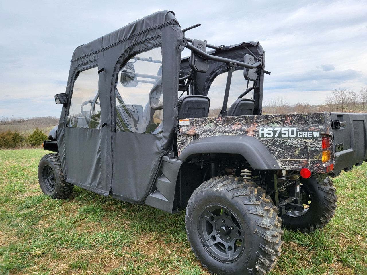 Rear three-quarter view of the 3 Star soft doors on a camo HiSun HS 750 Crew with open cargo bed