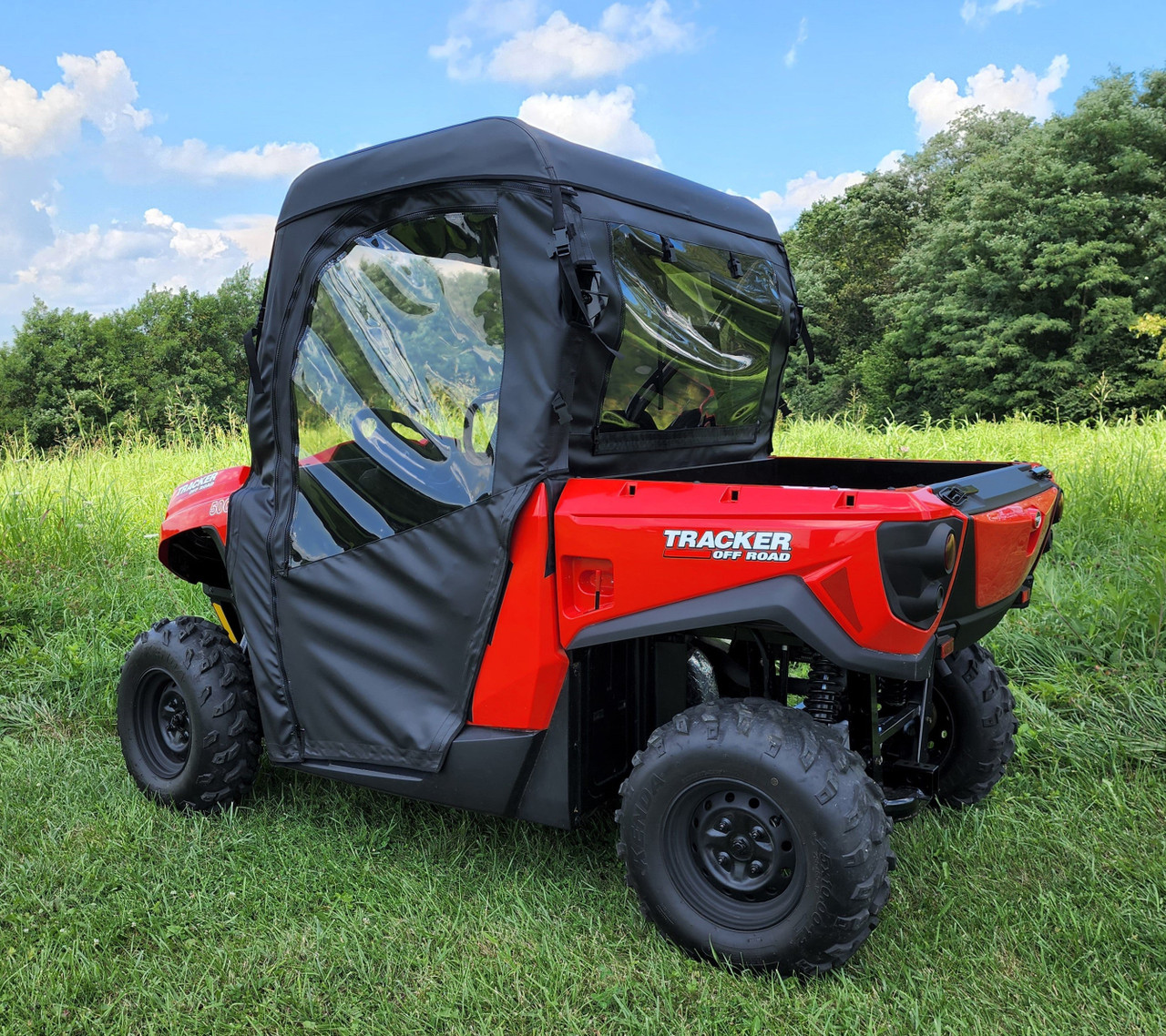 3 Star full cab enclosure with soft doors on a red side-by-side, rear three-quarter view in a field