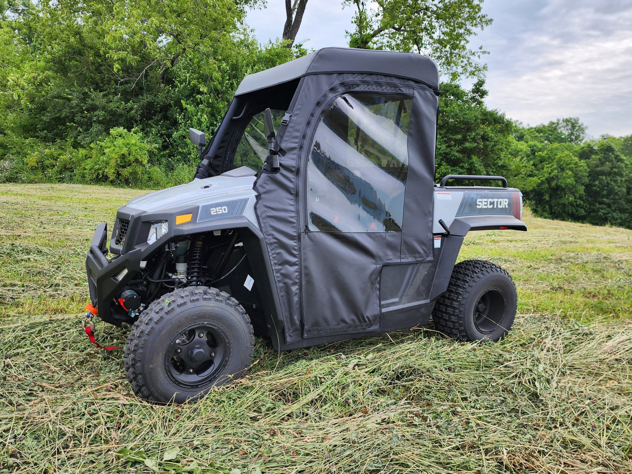 Front three-quarter view of a HiSun Sector 250 with the 3 Star full cab enclosure doors and top on grass