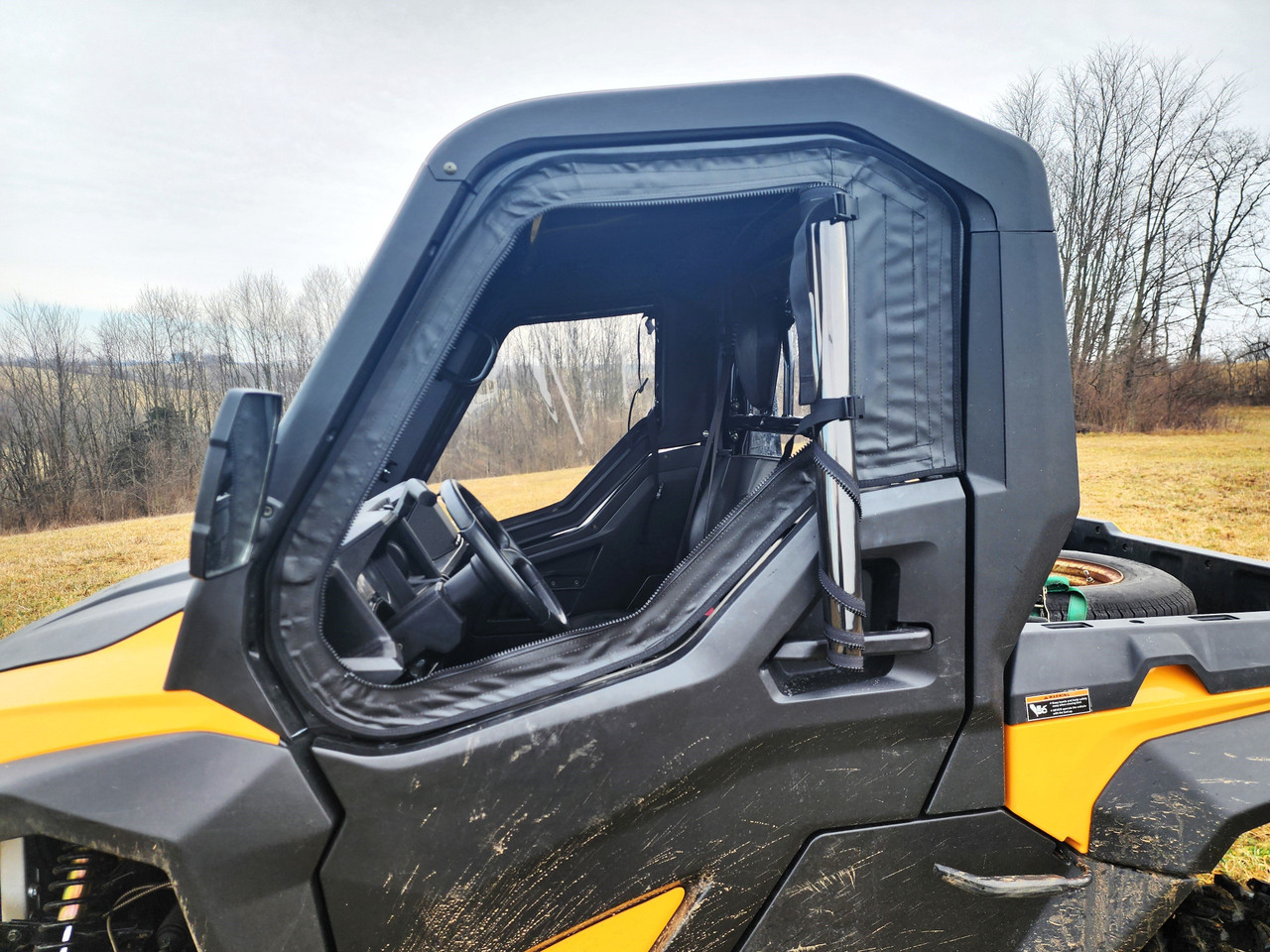 Close-up of the 3 Star upper door with clear window on the Cub Cadet Challenger MX, driver side