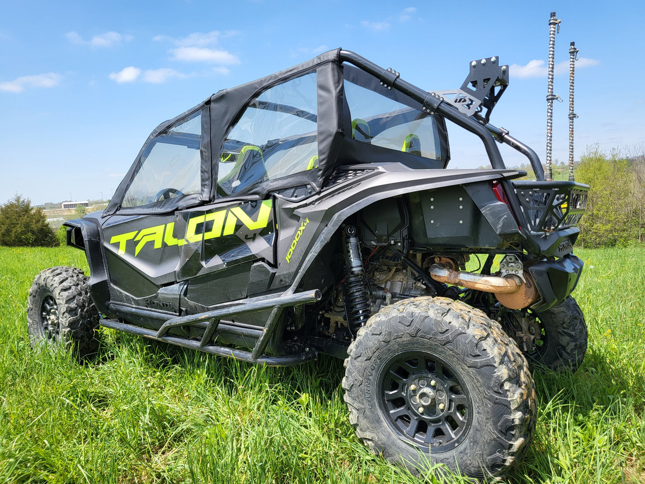 Driver side rear view of the 3 Star upper doors and rear window combo on a Honda Talon 4-Seater on grass
