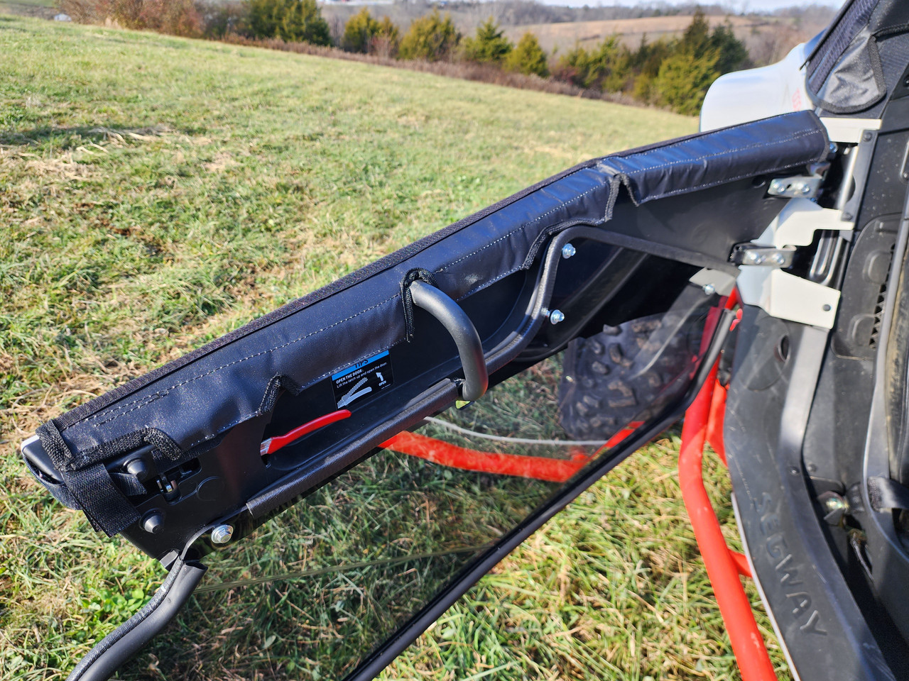 3 Star upper soft door on a Segway Villain swung open, side view showing the hinge edge and strap along the top