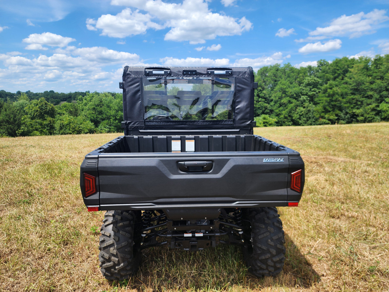 Straight rear view of the 3 Star soft rear panel with window above the TGB LandMax 1000 cargo bed