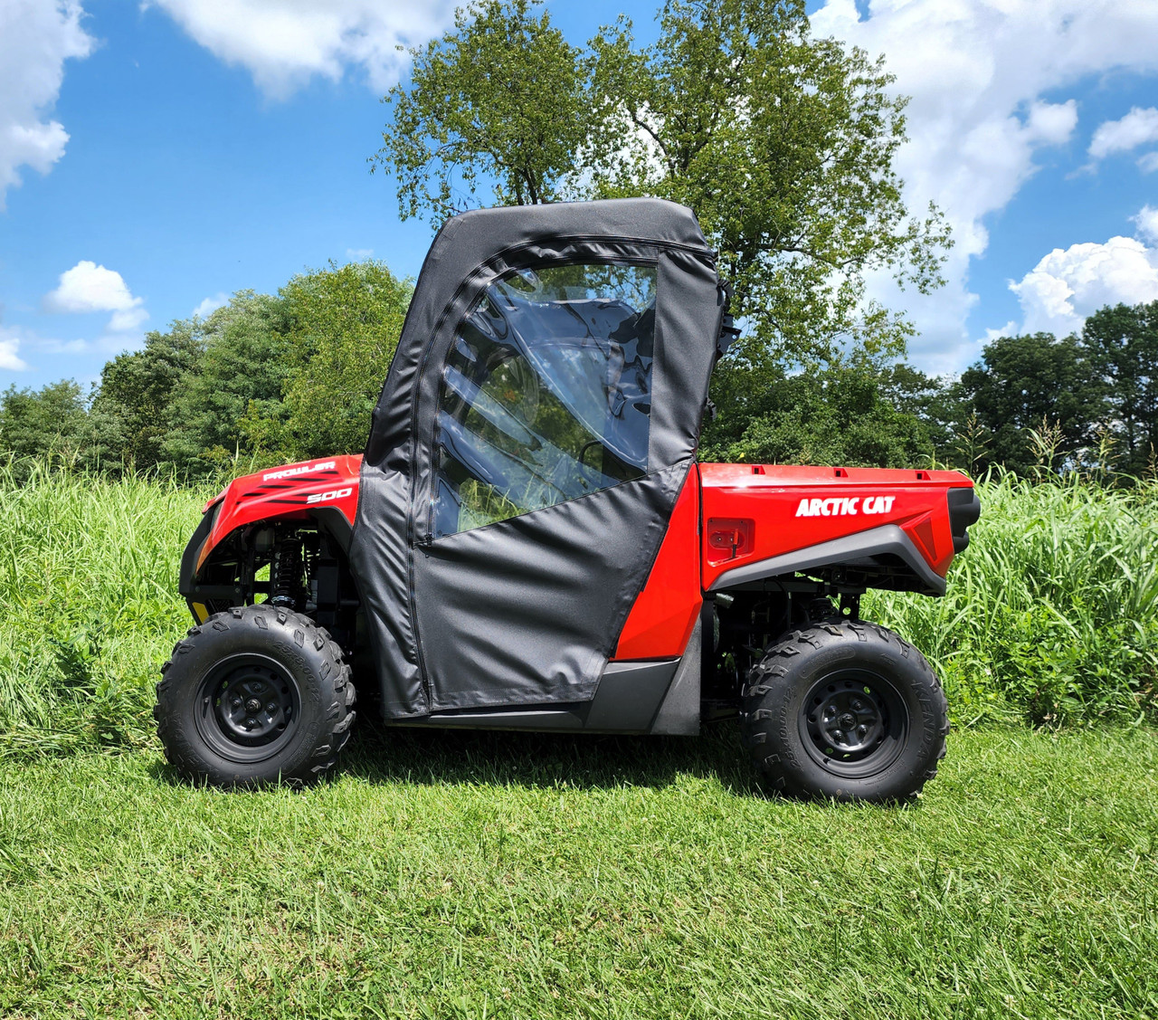 Driver side profile of the 3 Star soft door with clear window on the red Arctic Cat Prowler 500