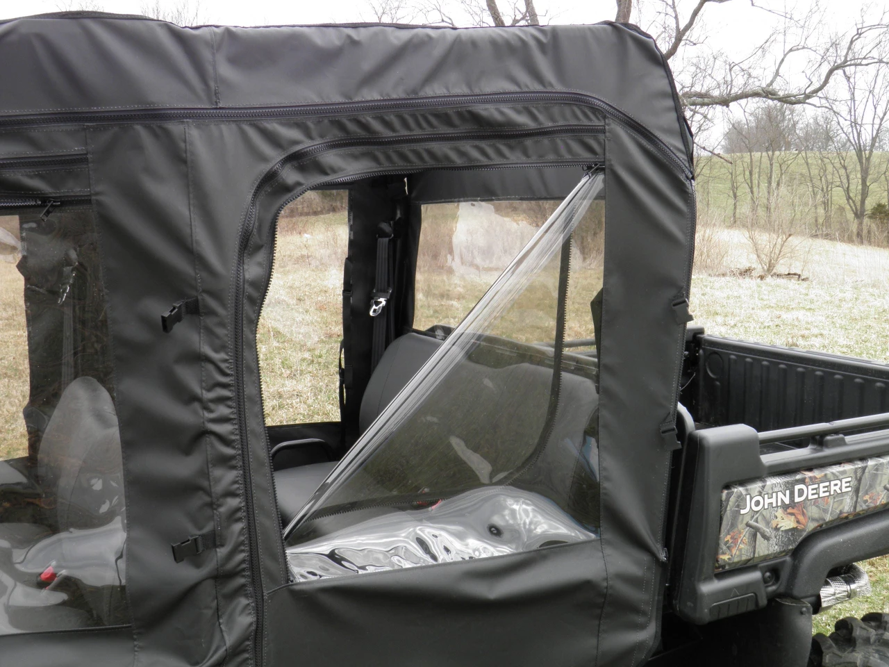Close-up of a 3 Star half door upper panel with clear vinyl window on a camo side-by-side