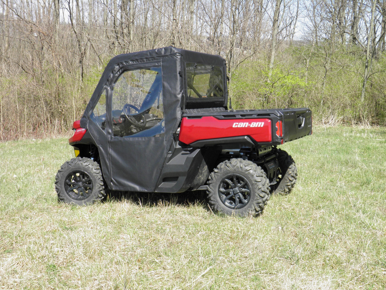 Driver side profile of the 3 Star door and rear window combo on a red Can-Am Defender on dry grass