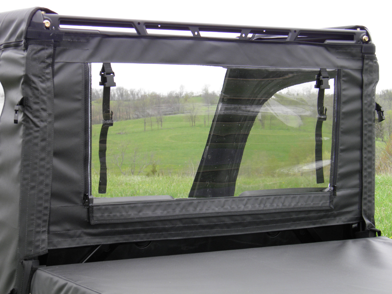 Close-up of the 3 Star rear window panel on a Polaris Ranger 570 Mid-Size, clear window with two roll-up straps