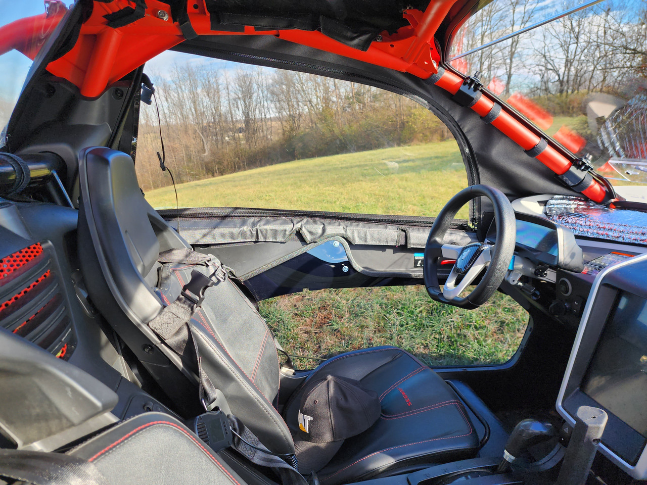 Inside view of the 3 Star upper doors on a Segway Villain from the passenger side, black seats and red cage visible