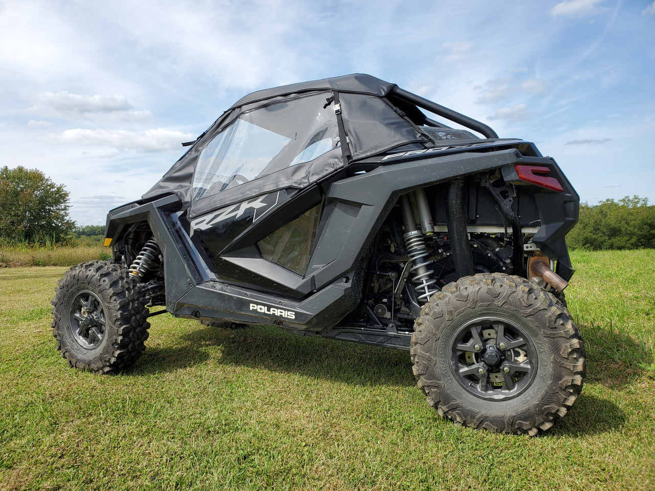 3 Star soft doors and rear window combo on a gray Polaris RZR Pro XP, front three-quarter view in a field