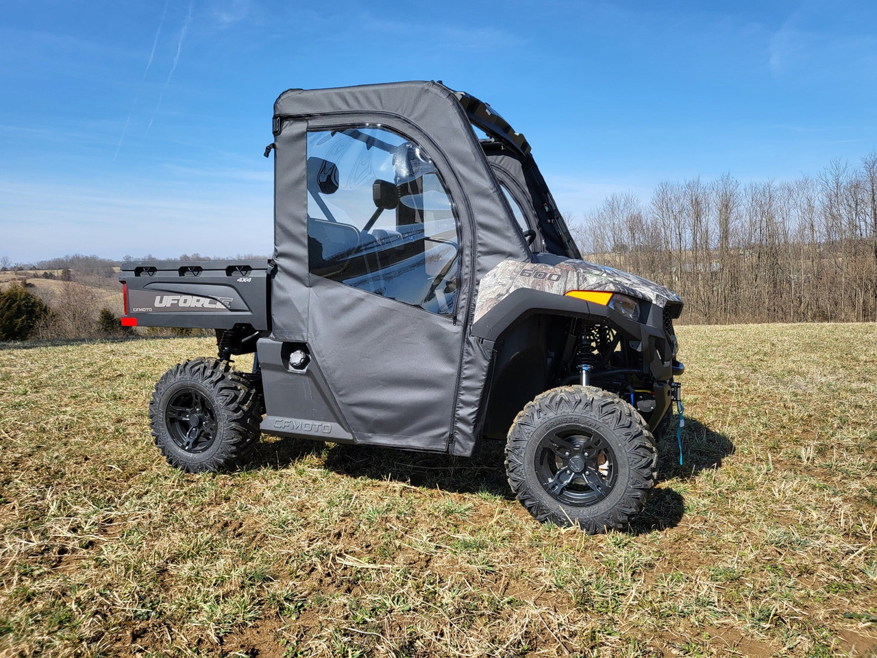 3 Star soft doors on a gray and camo CFMoto UForce 600, driver side front three-quarter view in a winter field