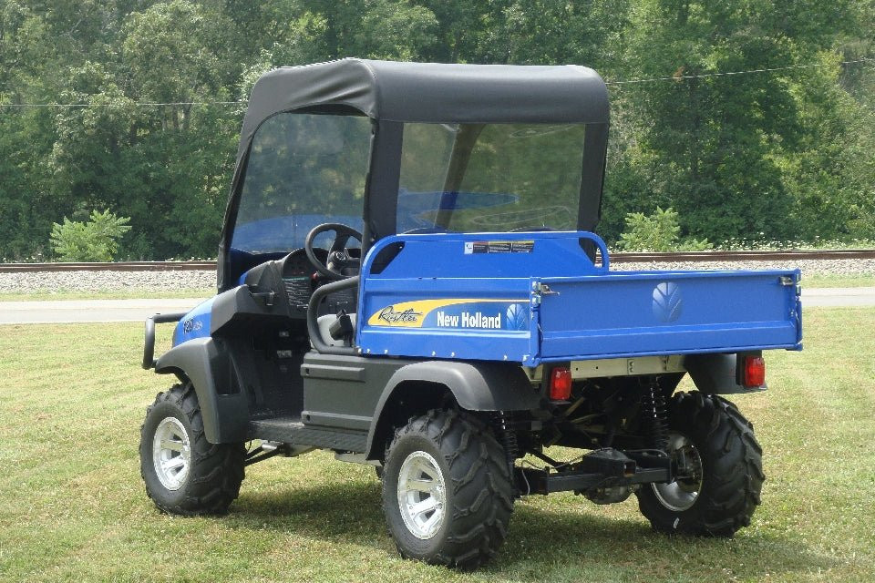 3 Star vinyl windshield and soft top on a blue New Holland Rustler 115, rear three-quarter view in a field