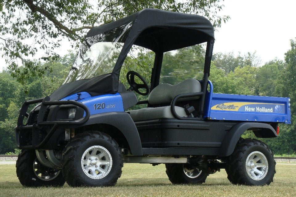 Front three-quarter view of a blue New Holland Rustler 115 with the 3 Star vinyl windshield and top combo