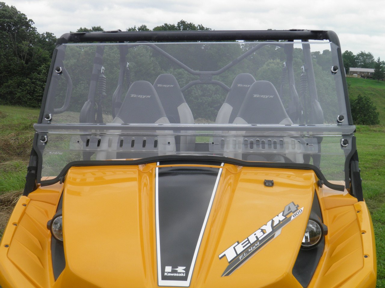 3 Star one-piece vented windshield on a yellow Kawasaki Teryx 4-seater, straight front view over the hood