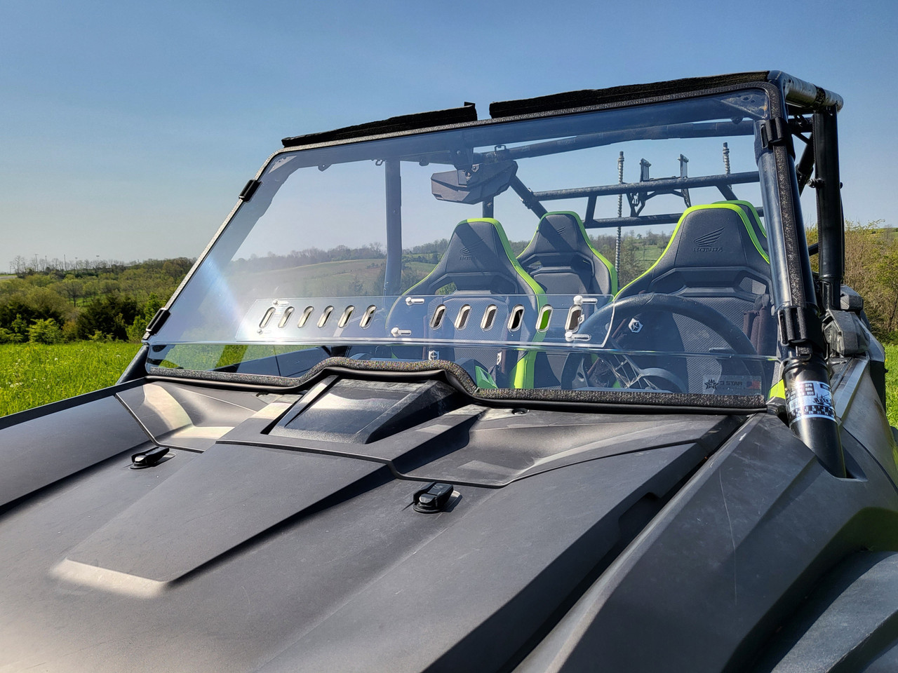Front view over the hood of the Honda Talon 4-seater showing the 3 Star windshield and its vent slots