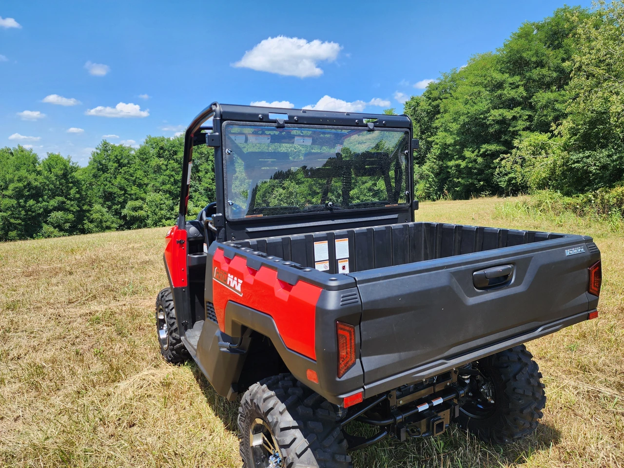 Rear three-quarter view of a red side-by-side with the 3 Star polycarbonate rear windshield behind the cab