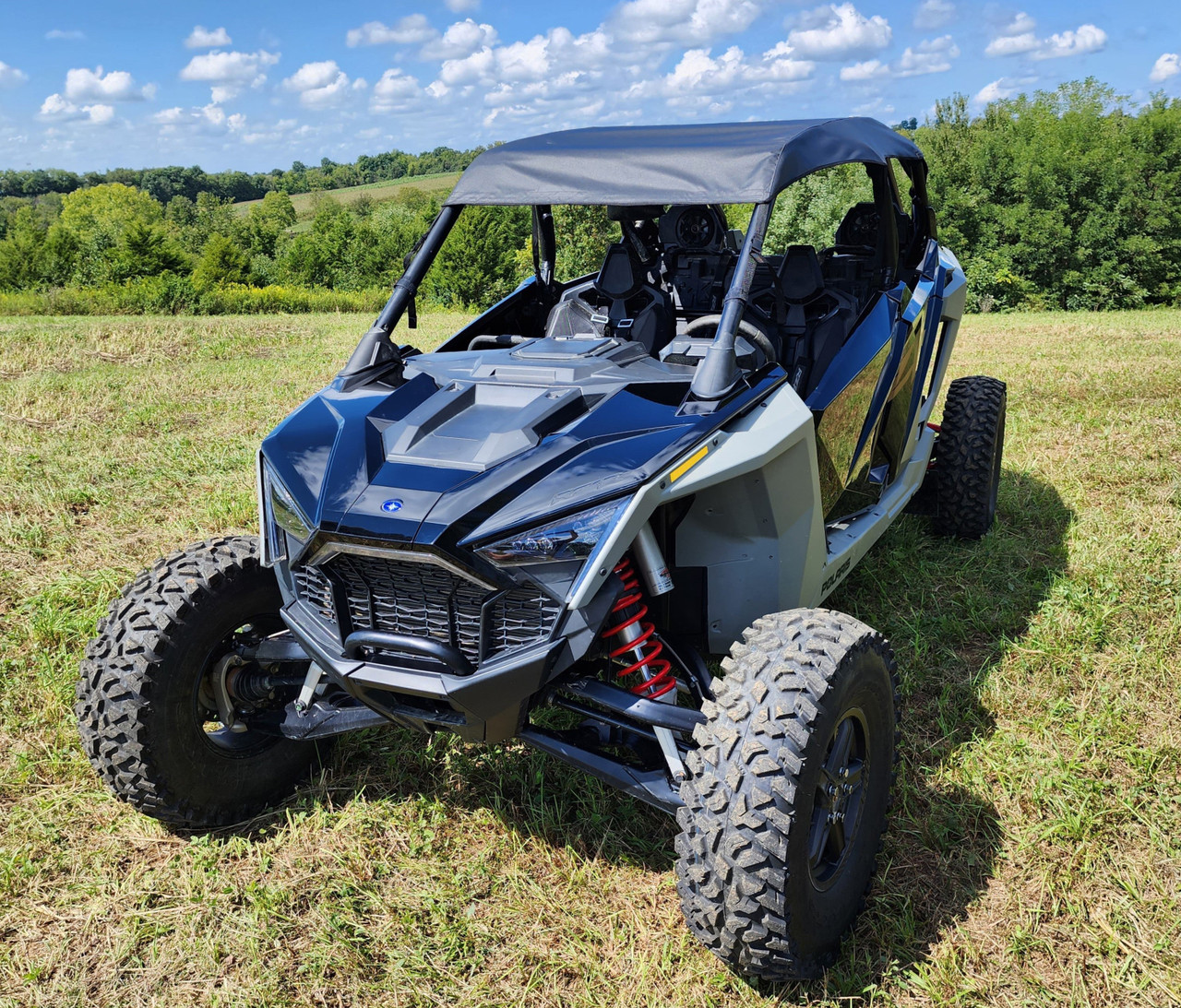3 Star soft top on a blue and gray Polaris RZR Pro XP 4, front three-quarter view in a mowed field