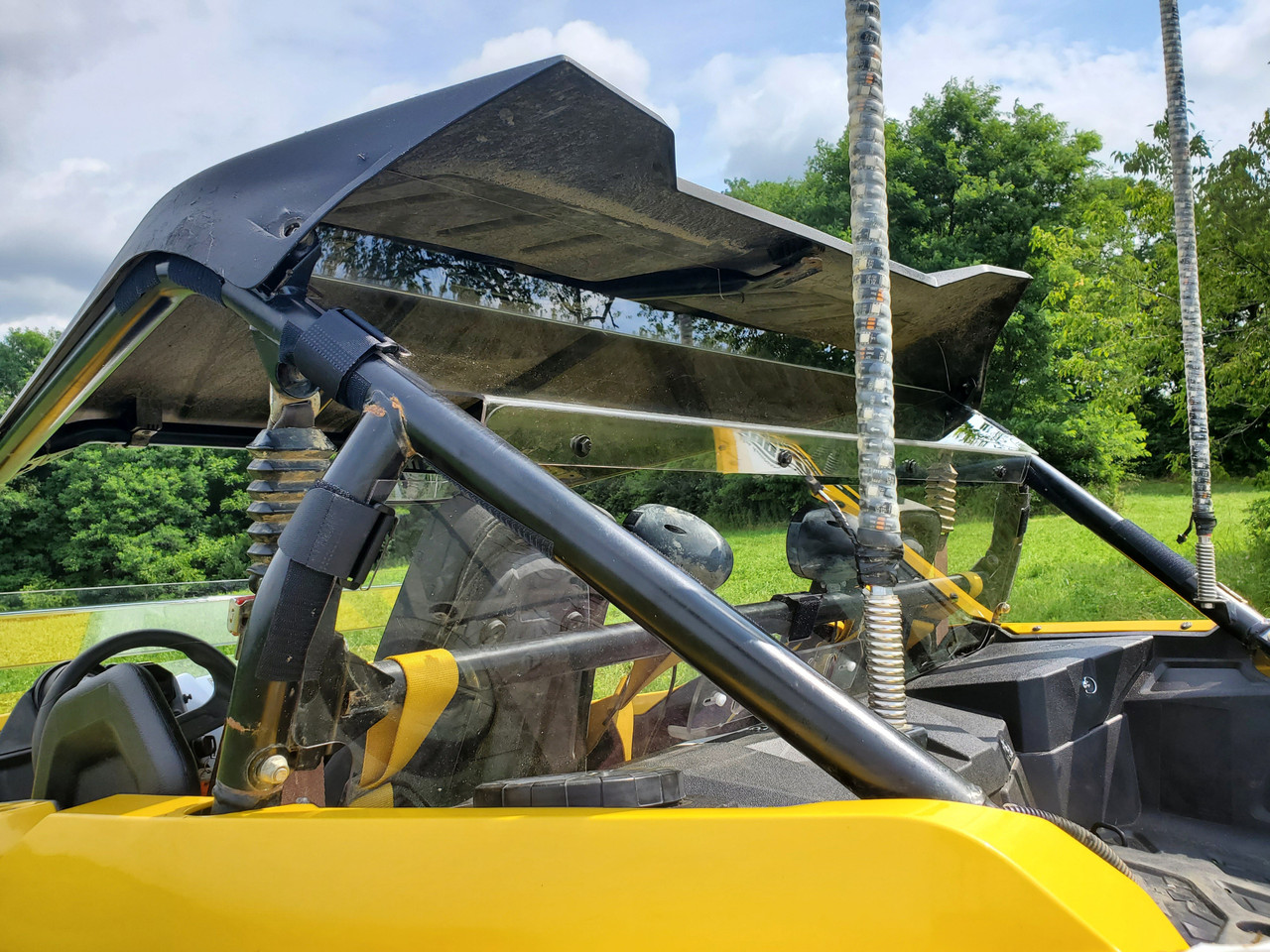 3 Star 2-piece Lexan back panel installed behind the seats of a yellow Yamaha YXZ, driver side view