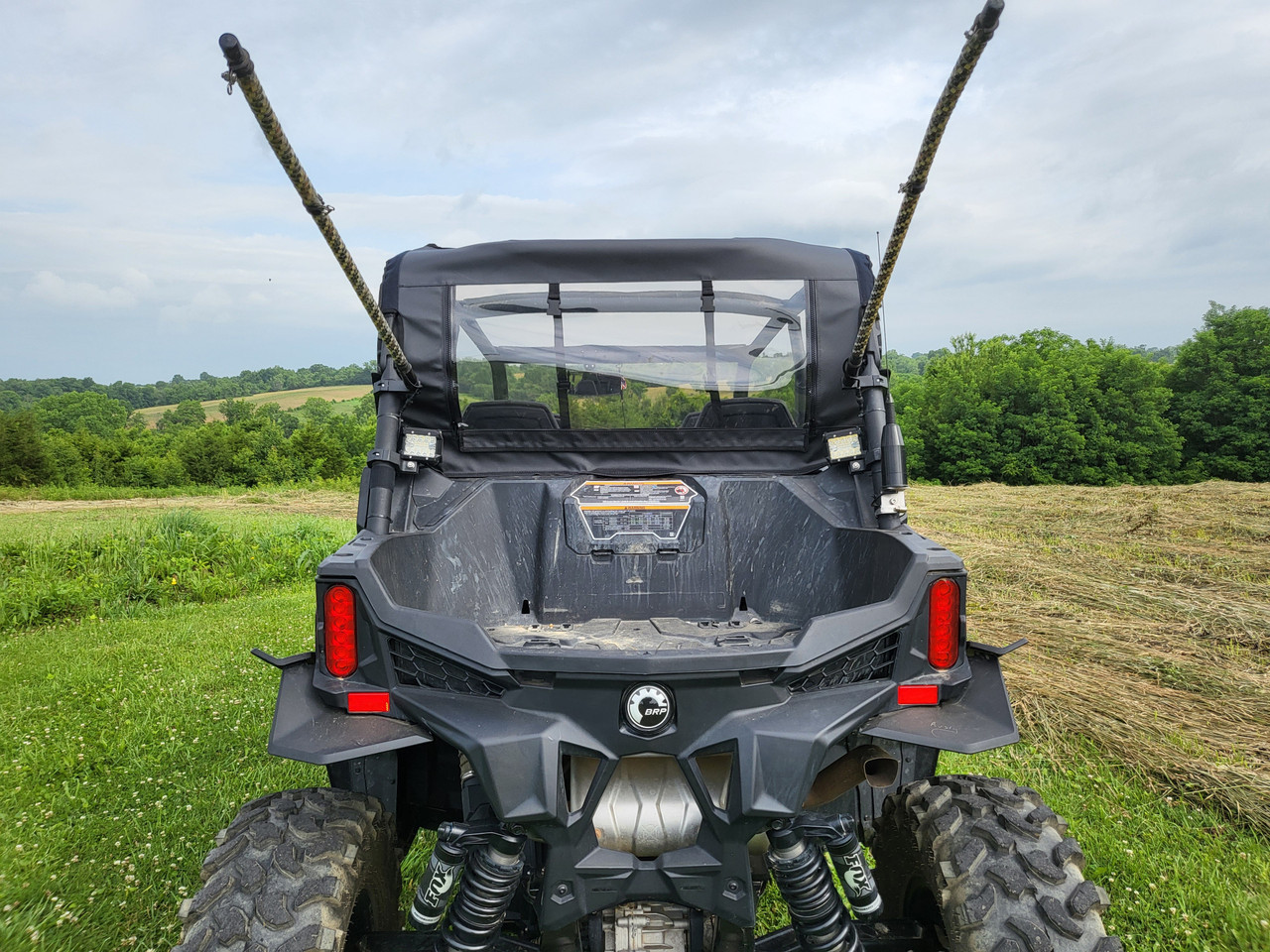 3 Star canvas rear panel with clear window on a Can-Am Maverick Trail, straight rear view in a field